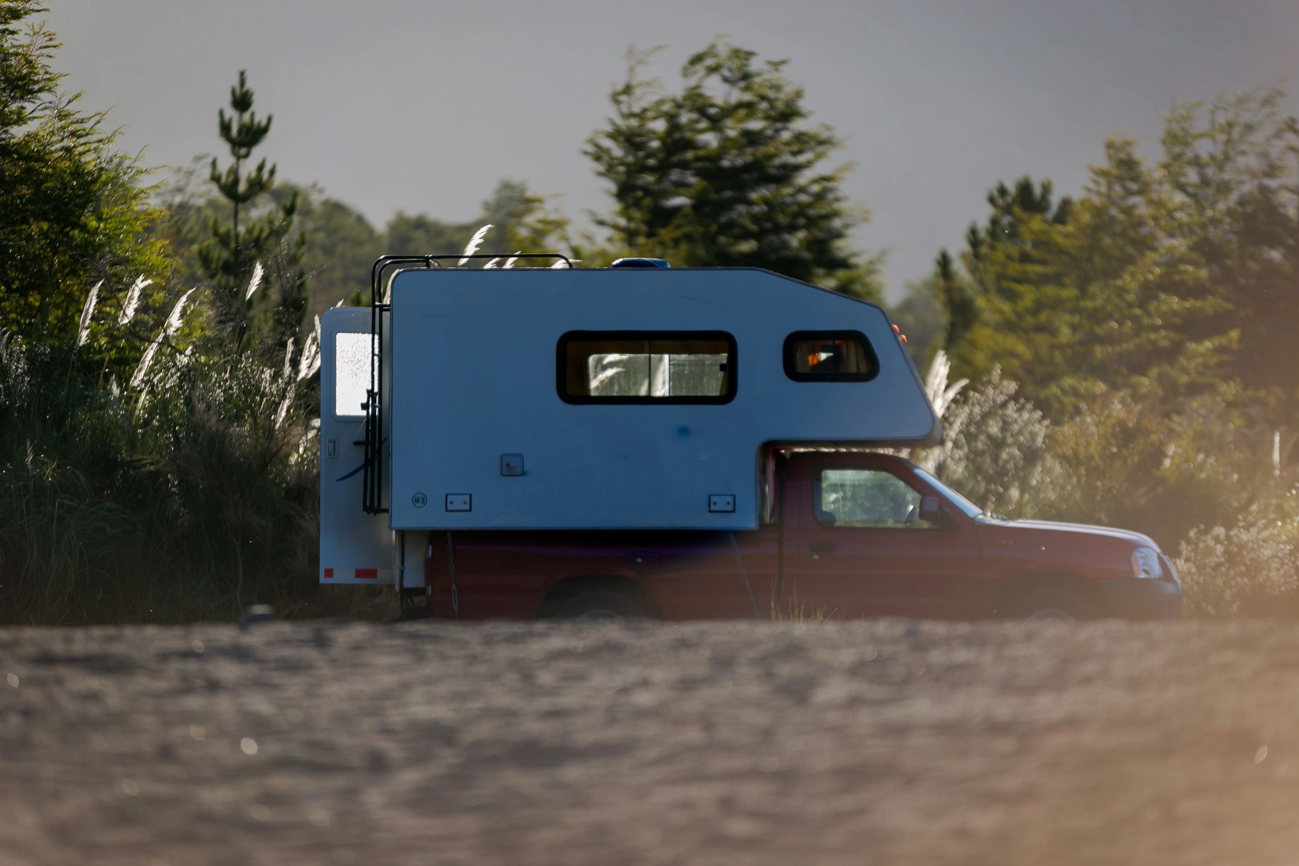 Custom popup camper prepared for exterior utility upgrades