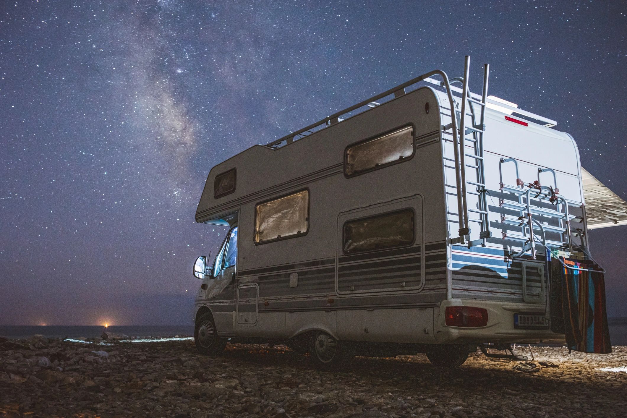 Popup camper parked outdoors beside the road